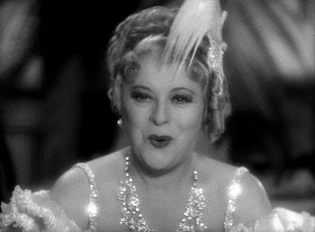 Movie still from “Ruggles of Red Gap” (1935), directed by Leo McCarey – An old photo of a woman in a dress with feathers on her head; Close Up shot, Low angle
