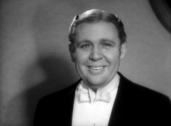 Movie still from “Ruggles of Red Gap” (1935), directed by Leo McCarey – An old photo of a man wearing a bow tie; Close Up shot, Low angle