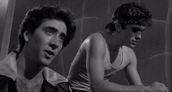 Movie still from “Rumble Fish” (1983), directed by Francis Ford Coppola – Two young men are sitting on a wall; Close Up shot, Over the shoulder angle