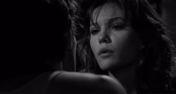 Movie still from “Rumble Fish” (1983), directed by Francis Ford Coppola – A black - and - white photo of a woman looking into a mirror; Close Up shot, Over the shoulder angle