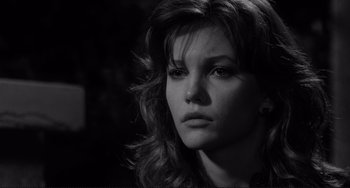 Movie still from “Rumble Fish” (1983), directed by Francis Ford Coppola – A black - and - white photo of a woman looking at the camera; Close Up shot, Over the shoulder angle