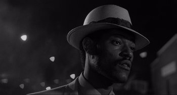 Movie still from “Rumble Fish” (1983), directed by Francis Ford Coppola – A black and white photo of a man wearing a hat; Close Up shot, Low angle