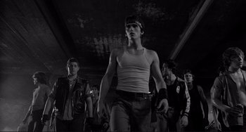 Movie still from “Rumble Fish” (1983), directed by Francis Ford Coppola – A group of young men standing next to each other; Medium shot, Low angle