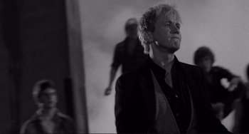 Movie still from “Rumble Fish” (1983), directed by Francis Ford Coppola – Black and white photograph of a man in a suit; Close Up shot, Low angle