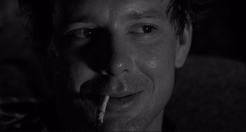 Movie still from “Rumble Fish” (1983), directed by Francis Ford Coppola – A person smoking a cigarette; Close Up shot, Low angle