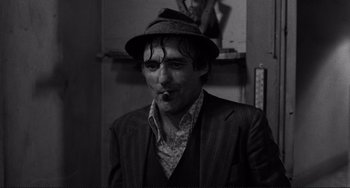 Movie still from “Rumble Fish” (1983), directed by Francis Ford Coppola – A black and white photo of a man smoking a cigarette; Close Up shot, Low angle