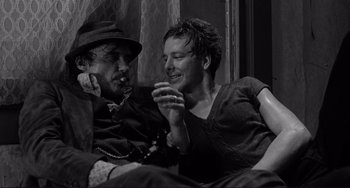 Movie still from “Rumble Fish” (1983), directed by Francis Ford Coppola – A man and a woman sitting next to each other on a couch; Close Up shot, Low angle