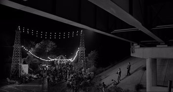 Movie still from “Rumble Fish” (1983), directed by Francis Ford Coppola – A black and white photo of people at a party; Extreme Wide shot, High angle