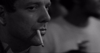 Movie still from “Rumble Fish” (1983), directed by Francis Ford Coppola – A person holding a cigarette in his mouth; Close Up shot, Low angle