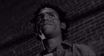 Movie still from “Rumble Fish” (1983), directed by Francis Ford Coppola – Black and white photograph of a man looking up; Close Up shot, Low angle