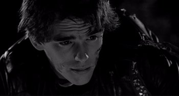 Movie still from “Rumble Fish” (1983), directed by Francis Ford Coppola – A young man looking into the distance with a serious look; Close Up shot, Low angle