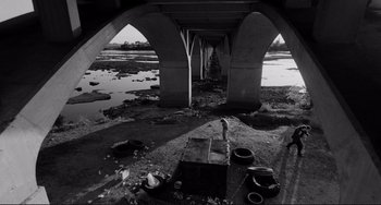 Movie still from “Rumble Fish” (1983), directed by Francis Ford Coppola – A black - and - white photo of an underside of a bridge; Extreme Wide shot, High angle
