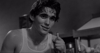 Movie still from “Rumble Fish” (1983), directed by Francis Ford Coppola – A young man holding a toothbrush in his hand; Close Up shot, Over the shoulder angle