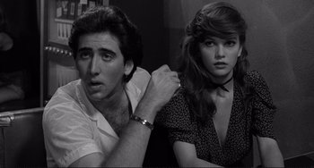 Movie still from “Rumble Fish” (1983), directed by Francis Ford Coppola – A man and a woman sitting next to each other; Close Up shot, Over the shoulder angle