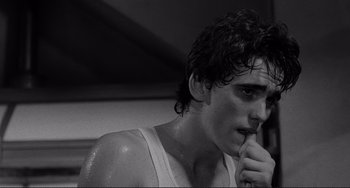 Movie still from “Rumble Fish” (1983), directed by Francis Ford Coppola – Black and white photograph of a young man with wet hair; Close Up shot, Low angle