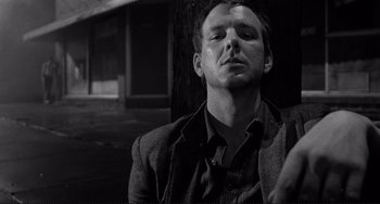 Movie still from “Rumble Fish” (1983), directed by Francis Ford Coppola – Black and white photograph of a man in a suit; Close Up shot, Low angle