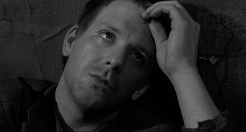 Movie still from “Rumble Fish” (1983), directed by Francis Ford Coppola – Black and white photograph of a young man with his head resting on his hand; Close Up shot, Low angle