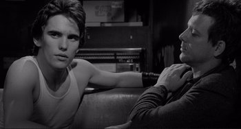 Movie still from “Rumble Fish” (1983), directed by Francis Ford Coppola – A man and a woman sitting next to each other on a couch; Close Up shot, Over the shoulder angle