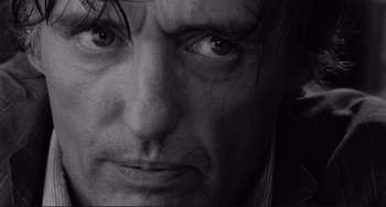 Movie still from “Rumble Fish” (1983), directed by Francis Ford Coppola – A man's face in black - and - white; Extreme Close Up shot, Low angle