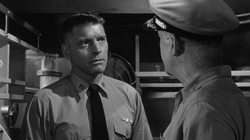Movie still from “Run Silent Run Deep” (1958), directed by Robert Wise – A man in uniform talking to another man in uniform; Close Up shot, Over the shoulder angle