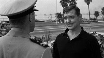 Movie still from “Run Silent Run Deep” (1958), directed by Robert Wise – A man in a uniform talking to another man in a uniform; Close Up shot, Over the shoulder angle