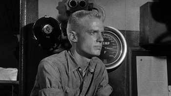 Movie still from “Run Silent Run Deep” (1958), directed by Robert Wise – A black and white photo of a man in a room; Medium shot, Low angle