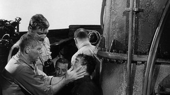 Movie still from “Run Silent Run Deep” (1958), directed by Robert Wise – A group of men standing next to each other on top of a boat; Medium shot, Over the shoulder angle