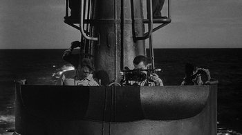 Movie still from “Run Silent Run Deep” (1958), directed by Robert Wise – A black - and - white photo of men working on a ship; Medium shot, High angle