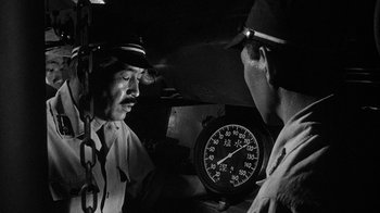 Movie still from “Run Silent Run Deep” (1958), directed by Robert Wise – Two men are talking in front of a clock; Close Up shot, Low angle