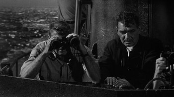 Movie still from “Run Silent Run Deep” (1958), directed by Robert Wise – Two men looking through binoculars while standing next to each other; Medium shot, High angle