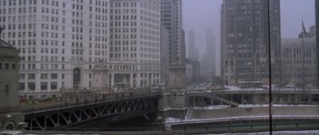 Movie still from “Running Scared” (1986), directed by Peter Hyams – A bridge that is going over a body of water; Extreme Wide shot, High angle