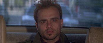 Movie still from “Running Scared” (1986), directed by Peter Hyams – A person wearing a jacket; Close Up shot, Low angle