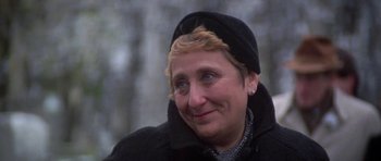 Movie still from “Running Scared” (1986), directed by Peter Hyams – A person wearing a hat and a jacket; Close Up shot, Over the shoulder angle