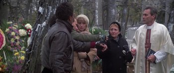 A group of people standing around each other in the snow