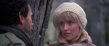 Movie still from “Running Scared” (1986), directed by Peter Hyams – A person wearing a hat near a tree; Close Up shot, Over the shoulder angle