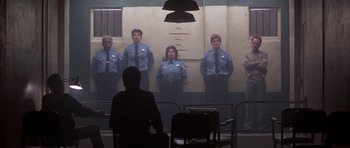 Movie still from “Running Scared” (1986), directed by Peter Hyams – A group of men standing in front of each other; Wide shot, Low angle
