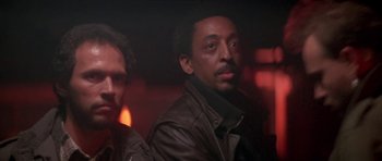 Movie still from “Running Scared” (1986), directed by Peter Hyams – A man in a leather jacket is looking into the camera; Close Up shot, Low angle