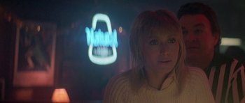 Movie still from “Running Scared” (1986), directed by Peter Hyams – A woman in front of a projection of a neon sign; Close Up shot, Over the shoulder angle