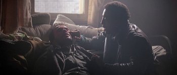 Movie still from “Running Scared” (1986), directed by Peter Hyams – A man and a woman talking on a couch; Close Up shot, Over the shoulder angle