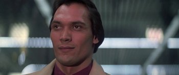 Movie still from “Running Scared” (1986), directed by Peter Hyams – A person wearing a suit and tie; Close Up shot, Low angle