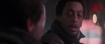 Movie still from “Running Scared” (1986), directed by Peter Hyams – A man in a leather jacket talking to another man in a leather jacket; Close Up shot, Over the shoulder angle