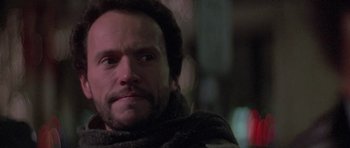 Movie still from “Running Scared” (1986), directed by Peter Hyams – A person wearing a scarf; Close Up shot, Low angle