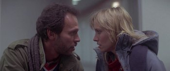 Movie still from “Running Scared” (1986), directed by Peter Hyams – A man and a woman face to face in front of a mirror; Close Up shot, Low angle