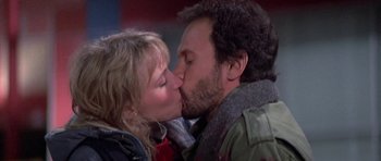 Movie still from “Running Scared” (1986), directed by Peter Hyams – A man and a woman kissing each other on the lips; Close Up shot, Low angle