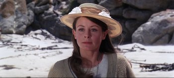 Movie still from “Ryan's Daughter” (1970), directed by David Lean – A woman wearing a hat in the middle of a snowy field; Close Up shot, Over the shoulder angle