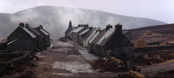 Movie still from “Ryan's Daughter” (1970), directed by David Lean – A row of houses on the side of a road; Extreme Wide shot, High angle