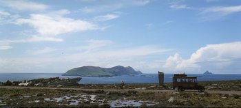 Movie still from “Ryan's Daughter” (1970), directed by David Lean – A man standing next to a body of water; Extreme Wide shot, Low angle