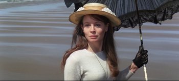 Movie still from “Ryan's Daughter” (1970), directed by David Lean – A woman in a hat standing in front of a body of water; Close Up shot, Low angle