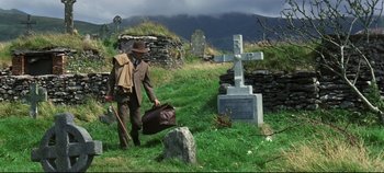 Movie still from “Ryan's Daughter” (1970), directed by David Lean – A man walking through a field carrying a bag of luggage; Wide shot, Low angle