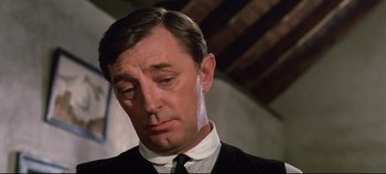 Movie still from “Ryan's Daughter” (1970), directed by David Lean – A person wearing a suit and tie; Close Up shot, Low angle